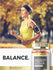 A young woman jogging outdoors while holding a bottle of Magnesium Gummies.
