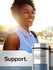 Young African American woman smiling in sunlight with a Horbaach Magnesium Citrate bottle outdoors.