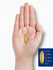 A yellow softgel capsule is displayed next to a ruler, measuring 1 inch in length.