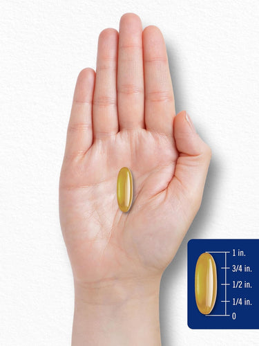 A yellow softgel capsule is displayed next to a ruler, measuring 1 inch in length.