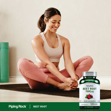 A young adult woman practicing a yoga pose next to a bottle of Beet Root.
