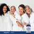 Four joyful women of different ages laugh and hug each other near a bottle of Biotin.