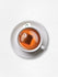Cup of Blood Pressure Tea with tea bag steeping on a white saucer.