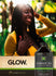 Lifestyle image of smiling woman with long braided hair, Jamaican Black Castor Oil bottle, and graphic stating GLOW.