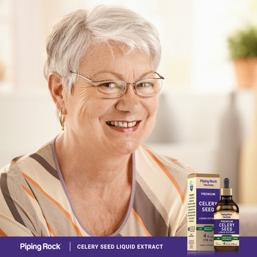 Smiling older woman next to a Celery Seed Liquid Extract box and bottle.