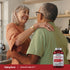 An older couple hugging in their kitchen, with a Cholest-Health bottle prominently on the counter.
