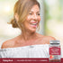 Middle-aged woman laughing while holding a Collagen Gummies bottle, looking to the side.