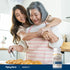 Two Asian women, one young and one older, embrace while baking croissants with a DIGEST-IT bottle close by.