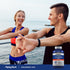 A young man and woman stretch outdoors by the water with a Hyaluronic Acid bottle visible nearby.