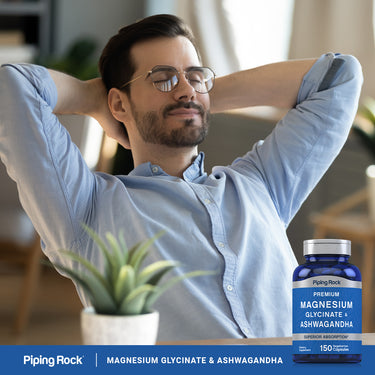 A man reclining with eyes closed and hands behind his head, next to a Magnesium Glycinate & Ashwagandha bottle.
