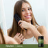A young woman brushes her hair next to a Horsetail bottle.