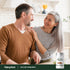 Middle-aged man and woman smiling at each other in a kitchen with a Ceylon Cinnamon bottle nearby.
