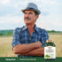 Middle-aged man in a field with arms crossed, looking left at a bottle of Phosphatidyl Choline.