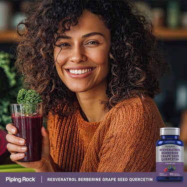 Young woman smiling with a smoothie beside a bottle of Resveratrol Berberine Grape Seed Quercetin Complex.