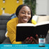 Young woman smiling while reading a book, next to an Ultra Brain Support bottle.