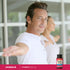A middle-aged man is stretching while holding a Vitamin C bottle, showcasing an active lifestyle and health focus.
