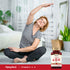 An elderly woman stretches on a mat next to a bottle of Vitamins A, D, and K.
