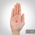 A single pink gummy held in a hand, measuring 0.75 inches (1.9 cm).