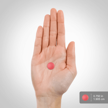A single pink gummy held in a hand, measuring 0.75 inches (1.9 cm).