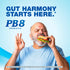 Older man happily eats a sandwich and makes an OK gesture, with visible PB8 Probiotic text in the background.