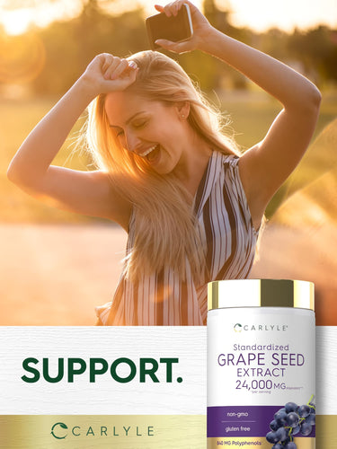 Woman laughing while holding a phone and a bottle of Carlyle Grape Seed Extract above her head.