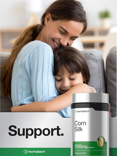 A smiling woman hugs a child with a Corn Silk bottle next to them, symbolizing care and skincare products.