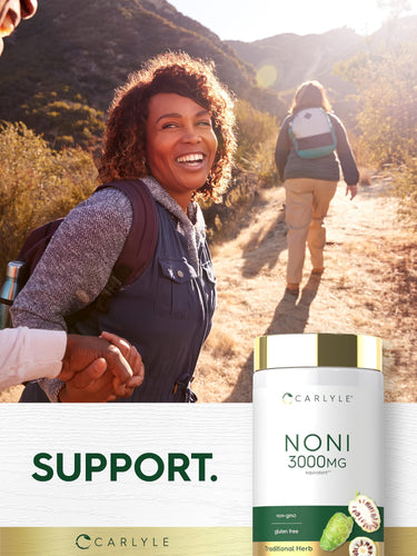 Middle-aged woman hiking on a sunny trail, holding hands, with a Carlyle Noni bottle prominent in the foreground.