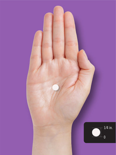Melatonin tablet shown in hand for size reference, measuring 1/4 in.