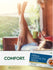 Lifestyle image of woman relaxing with her feet up while holding a mug, Carlyle Herbal Laxative Tea Senna box nearby, and graphic stating COMFORT.