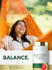 Lifestyle image of a smiling woman relaxing in an orange hammock with Grapefruit Seed Extract 500MG bottle and graphic stating BALANCE.