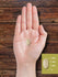 Grassfed Tallow softgel shown in hand for size reference, measuring approximately 5/8 in.