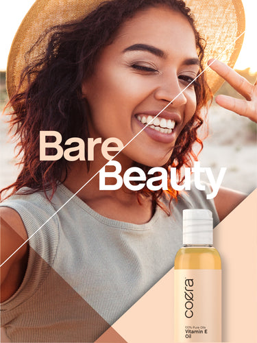 Lifestyle image of smiling adult wearing a sun hat with Coera Vitamin E Oil bottle and graphic stating Bare Beauty.