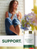 Lifestyle image of woman holding a cup by a window with Carlyle Acerola Cherry 1000MG bottle nearby and graphic stating SUPPORT.