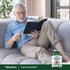 An older man reads a book and sips from a mug next to a bottle of Hawthorn Berries.