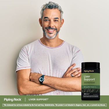 Middle-aged man smiling with arms crossed next to a bottle of Liver Support supplement.
