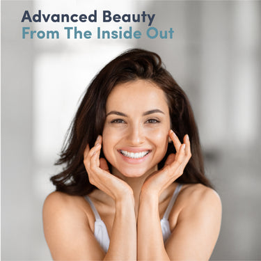 A young adult woman smiling with her hands on her cheeks.