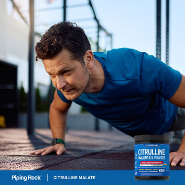 Adult performing a push-up outdoors, with a Fitness Labs Citrulline Malate 2:1 Powder container nearby