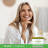 Lifestyle image of a smiling adult with a Piping Rock Cucumber Cream, 4 oz. (113 g), displayed in the bottom right corner