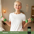 A senior woman exercises with green dumbbells next to a bottle of Green Lipped Mussel.
