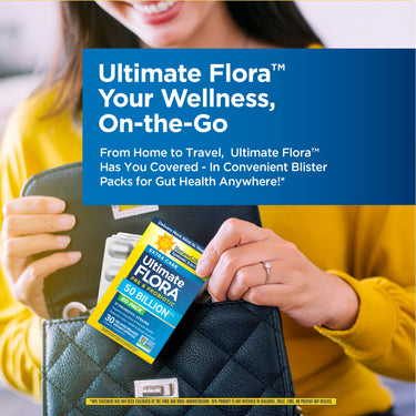 A young woman places a package of Ultimate Flora GO PACK into her black quilted purse.