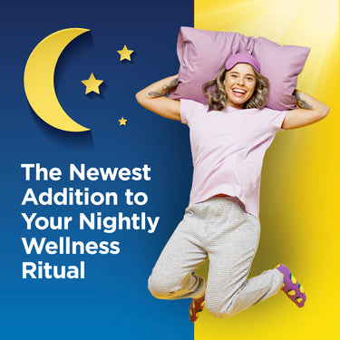 Young adult woman jumps happily in pajamas, holding a pillow, with text 'The Newest Addition to Your Nightly Wellness Ritual'.