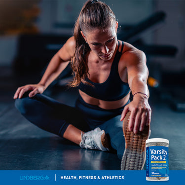 A young adult woman stretches next to a Varsity Pack 2 jar, promoting a healthy lifestyle.