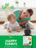 Mother smiles while playing with baby on the floor near a bottle of Lil' Sprouts Baby Probiotic Drops.